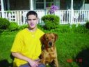 A blind young man with his guide dog.