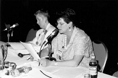 At the Resolutions Committee meeting Sharon Maneki reads into the microphone while Sharon Maneki listens