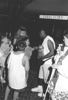 An adult volunteer hands out candy to scavengers who succeeded in finding him during their hunt.