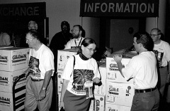 A group of people in campaign T-shirts, stand in front of the boxes of T-shirts ready to be handed out.