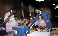 John Cheadle teaches campers about tools in the Center's workshop.