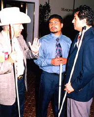 Norman Gardner, Jose Moncada, and Carlos Servan discuss Spanish translation of NFB convention agenda items.