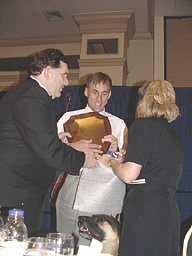 Allen Harris presents the Newell Perry Award plaque to Erik Weihenmayer.