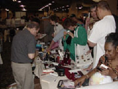 The exhibit hall is one of the most popular attractions.   Pictured here are a number of folks checking out the Independent Living Aids Display