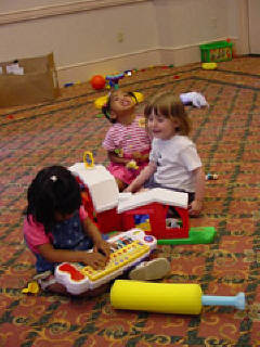 Three kids take advantage of the wide range of toys in NFB Camp