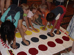 Kids enjoy a Braille version of the game Twister at the Braille Carnival.