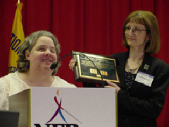 Nadine Jacobsen and Debra Bonde, who is holding her plaque