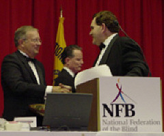 Dr. Daniel Reneau and Allen Harris shake hands.