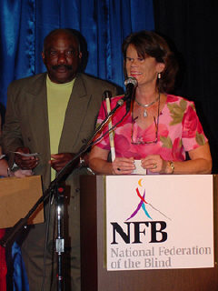Former Baltimore Oriole catcher and current coach Elrod Hendricks and Betsy Zaborowski stand together at the podium