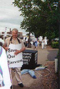 Larry Sebranek stands beside the black box with parts of a crushed blind consumer sticking out from around the bottom.