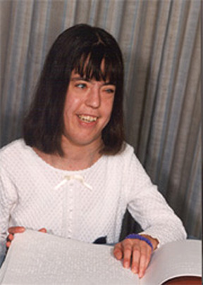 A young girl is pictured reading Braille.