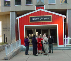 Standing in front of the Department of Education building and its little red school house, Federationists Donna Hartzell, Arkansas; Denna Lambert, Arkansas; Melody Lindsey, Michigan; Steve Handschu, Illinois; and and unidentified Federationist engage in animated discussion, no doubt wondering why the promise, "No child left behind," apparently does not include blind children.