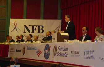 President Maurer delivers the banquet address as those at the head table look on.