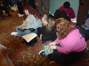Two college students sit on the floor to take notes during the great gathering-in.