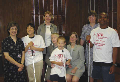 Maryland Braille Readers Are Leaders winners Laura Cefarrati, Jason Polansky, and Maurice Hamilton proudley wear "I am a winner" T-shirts.  Others pictured are (l-r) Jill Lewis, Maryland State Library for the Blimd and Visually Handicapped director, Sarah Bloomer, Friends of the Library for the  Blind and Physically Handicapped administrative assisstant; Sharon Maneki, NFB Maryland president; Barbara Cheadle, National Organization of Blind Children president; and Kit Bloom, Childrens' Library for the Blind and Physically Handicapprd librarian.   Each year Maryland contest participants receive their certificates at a party in the dining room of the National Center for the Blind, sponsored by the National Federation of the Blind of Maryland and the Maryland parents division.   The Friends of the Library present each participant with $10 and a congratulatory letter.