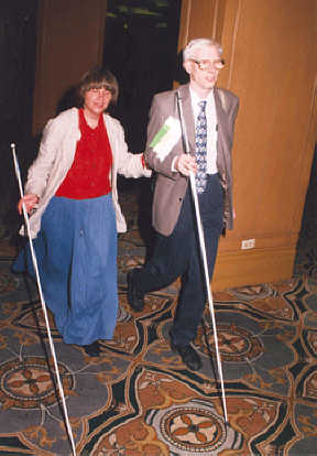 Peggy Elliott and Michael Gosse walk together using their canes.