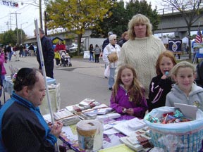 David Stayer, president of New York's Greater Long Island Chapter, distributes NFB literature and sells candy at the Bellmore Street Fair.