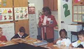 Ruby Polk uses the Braille Is Beautiful program, a disability awareness curriculum designed for elementary and middle school children, to show a Kansas City elementary class how Braille works.