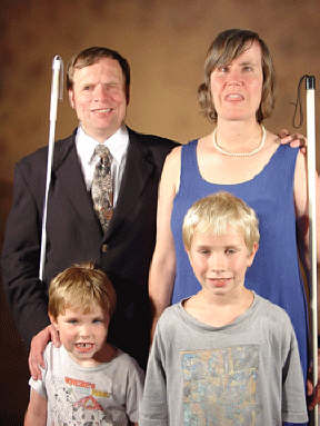 Paul and Mary Ellen Gabias with sons Elliott and Philip in front of them.