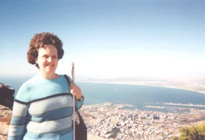 Patricia Maurer stands on Table Mountain,   Behind her part of Cape Town can be seen, including its newly renovated waterfront.