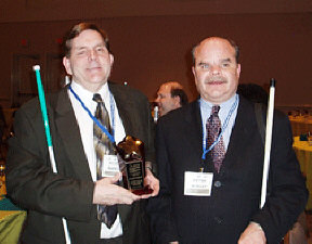 Kevan Worley, president of the National Association of Blind Merchants, presents the BLAST Gold Star Award to Allen Harris.   At BLAST we teach strategies and inspire attitudes that make it possible to reach for the stars.  In 2004, at the Orlando BLAST, we proudly recognized two leaders in Randolph-Sheppard and in work with the blind: Allen Harris, director of the Iowa Department for the Blind, and Terry Smith, director of Tennessee Services for the Blind.  Both received BLAST Gold Stars, symbolic of theur dedication to progressive advocacy on behalf of the blind in business.