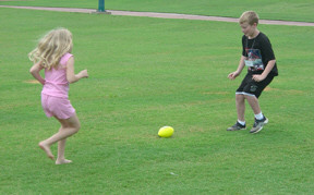 Jenna Altman (NE) and Daniel Davis (NC) playing in Centennial Park with a flourescent green ball