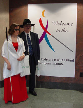 Barbara and Brad Loos (Nebraska) stand in front of the welcoming banner in the first-floor lobby of the Jernigan Institute, prepared to welcome guests.