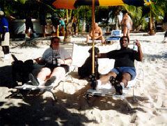 Pictured here Maryann and James Gilliard enjoy drinks on the beach in the Caribbean with their guide dogs.