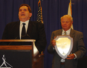 Allen Harris and Frank Kurt Cylke stand together with Mr. Cylke holding his plaque.