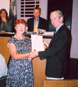 Charlottesville, Virginia, Mayor David Brown presents a proclamation to NFB chapter President Kathy Owen.