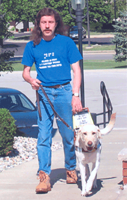 NFB of Illinois, Kankakee Heartland Chapter President Bryan Turner with his guide dog Madison walked from Momence to Reddick for Meet the Blind Month. Bryan's walk helped raise money for the chapter and increased the public's awareness about blindness and the work of the National Federation of the Blind of Illinois.