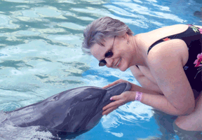 Calypso the dolphin greets Barbara Pierce.