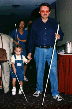 Jodi Jones and Mike Neese work with a child during the Cane Walk at convention.