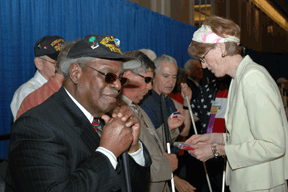 Marsha Dyer gives ribbons to the veterans on stage during the opening ceremonies.