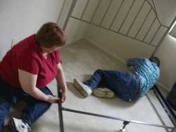 Jim McCarthy and his wife Terri Uttermohlen assemble Marsha Dyer�s bed at the end of a long day of moving.
