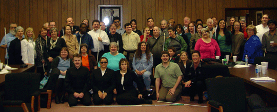 A large group ofpeople smile for the camera