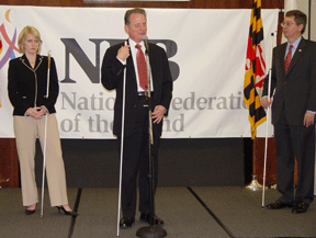 During the October Possibilities Fair for Seniors event held at the NFB Jernigan Institute in Baltimore, more than four hundred people heard President Maurer introduce Kristen Cox, Maryland's secretary of disabilities (cabinet-level position). Also pictured is John Par&eacute;, who served as the master of ceremonies during the fair.