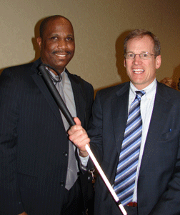 After addressing Federationists, Jack Kingston (right) visits with NFB of Georgia President Anil Lewis.