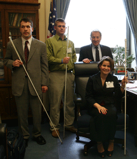 Congressman Ralph Regula of Ohio enjoys a spectacular view of the Capitol from his office window in the Rayburn Building. Here Jason Ewell and Luke Cassi (left) and Jennifer Kennedy (right) talk with him about appropriations of interest to the blind.