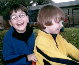 Vejas and Patras Vasiliauskas playing on the lawn of their California home. Blindness is no big deal to them.