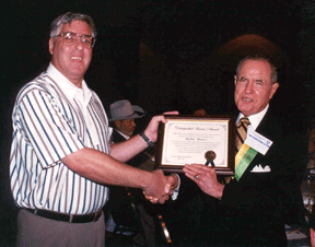 Michael Marucci receives the Distinguished Service Award plaque from Dr. Kenneth Jernigan.