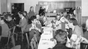 People seated at a long table in the Harbor Room