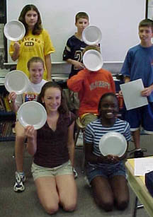 Davis Drive students play a game from the Braille Is Beautiful curriculum program.  Later, after they have learned the Braille dot positions, they will progress to writing Braille with a slate and stylus.   Before the program is finished, they will hand-Braille decks of UNO cards as a service project.