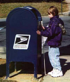 Rachel completes a mobility assignment; she locates a post office box and mails a letter.