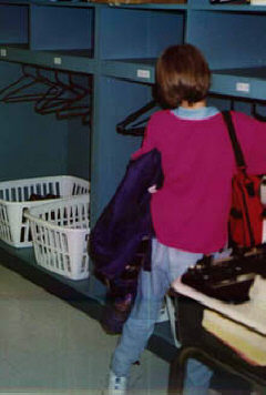 Rachel hangs up her coat: the school day begins