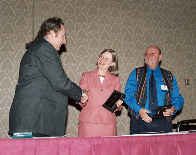 Rand Wobel, Executive Director, Lilliworks Active Learning Foundation, (left) presents Leadership Awards to Barbara Cheadle, President, National Organization of Parents of Blind Children, and to Joe Cutter, early childhood orientation and mobility specialist, at the 2005 North American Active Learning Convention in Oakland, California. Cheadle also accepts a plaque on behalf of the National Federation of the Blind.  A report on the conference can be found later in this issue.