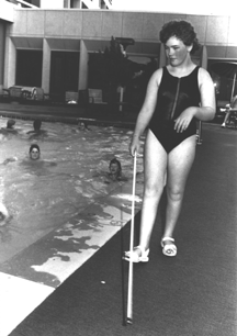 Terry Van Ettinger uses the cane to become familiar with a hotel pool area before taking a plunge.