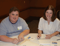 Shawn Payne and Anne Radavich sit at a table.