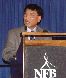 John Wai speaks to the 2006 convention. 