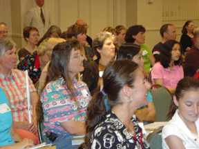 The crowd listens closely to Susan osterhaus